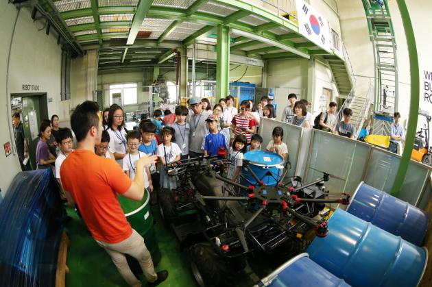 지난해 여름방학 ‘연구원 개방의 날’ 프로그램에서 참가자들이 로봇 연구실을 견학하고 있다.