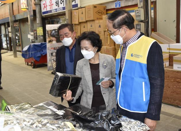 지난 14일 충남 보령시 보령전통시장에서 박형구 한국중부발전 사장(오른쪽)이 지역경제화폐로 물품을 구매하고 있다.