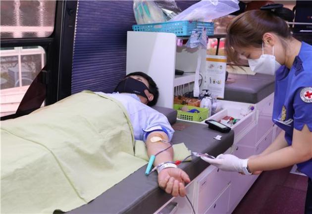 강신홍 기획경영본부 본부장(좌)이 헌혈을 하고 있다.