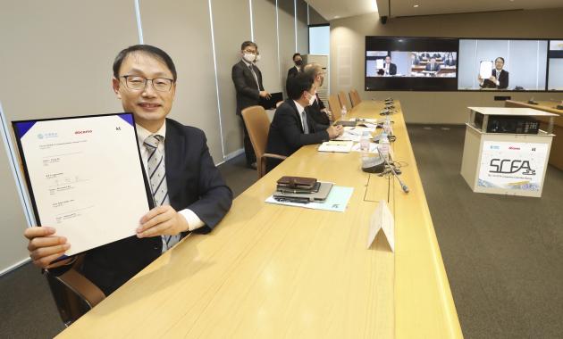  25일 화상으로 진행된 SCFA 총회에 참석한 구현모 KT 대표가 협약서에 서명 후 기념촬영을 하고 있다.